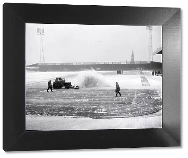 Birmingham grounds staff seen here clearing snow from the pitch. January 1963