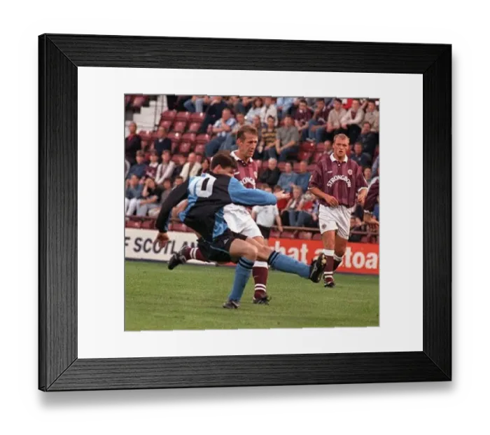  : Gareth Hutchison Stenhousemuir football player shoots for goal as hearts players Gary