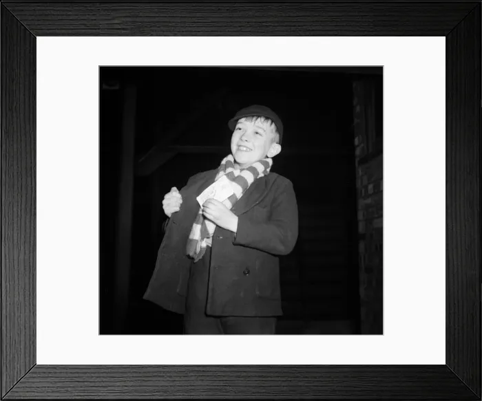 Framed Print : A young Brentford supporter smiles after receiving his ticket for the cup tie against Framed Print : A young Brentford supporter smiles after receiving his ticket for the cup tie against