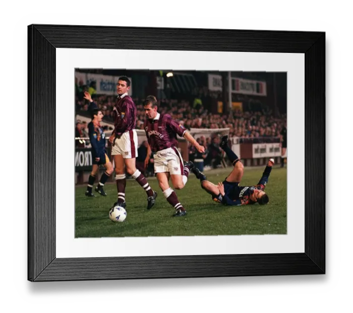 Framed Print : Gary Mackay of Hearts Football Club runs with the ball after tackling Paul Bernard of