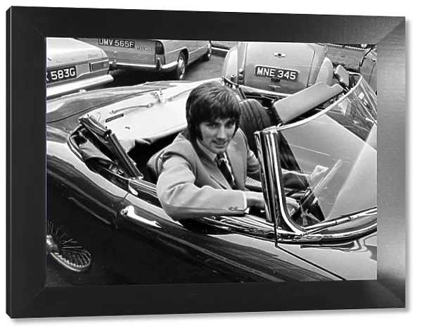George Best Football Player in sports car circa 1965