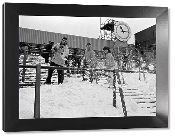 Clearing snow of the terraces at Highbury Stadium, home ground of Arsenal Football Club
