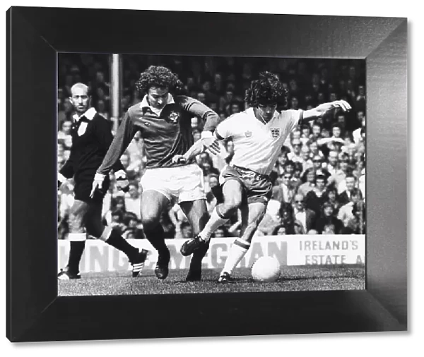 Englands Kevin Keegan shrugs off a tackle from a Northern Irelands Martin O