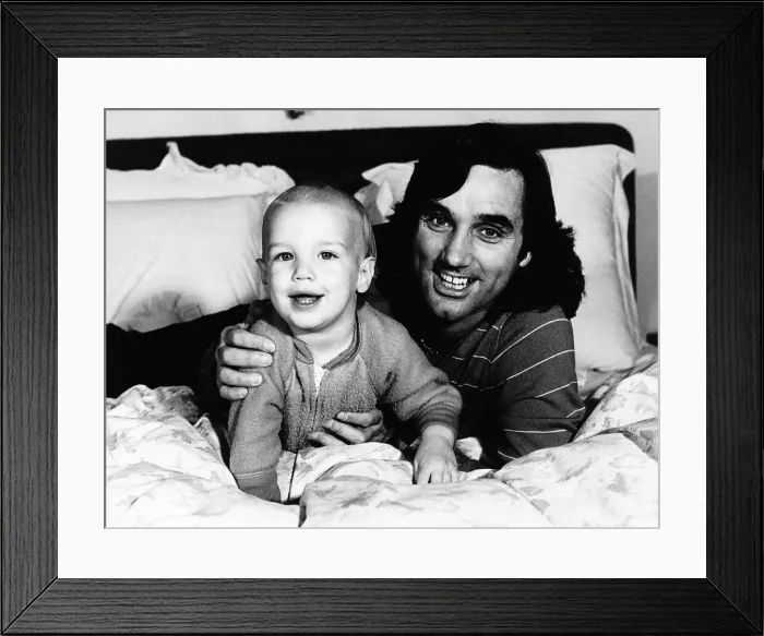 Framed Print : George Best football with his son Calum in 1982 Framed Print : George Best football with his son Calum in 1982