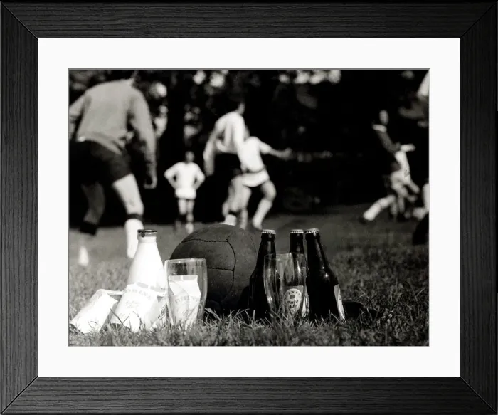 Framed Print : Drinkers beat a teetotal team in Luton. Beer and milk at touchline whilst teams Framed Print : Drinkers beat a teetotal team in Luton. Beer and milk at touchline whilst teams
