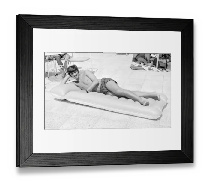 Framed Print : George Best relaxing on an inflatable bed whilst on holiday April 1967 Framed Print : George Best relaxing on an inflatable bed whilst on holiday April 1967