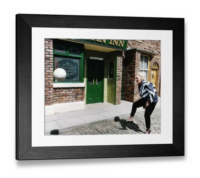 Framed Print : Liz Dawn Actress plays Vera in Coronation Street as she practices for a charity football