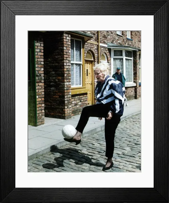 Framed Print : Liz Dawn Actress who plays the part of Vera Duckworth in Coronation Street kicks football Framed Print : Liz Dawn Actress who plays the part of Vera Duckworth in Coronation Street kicks football