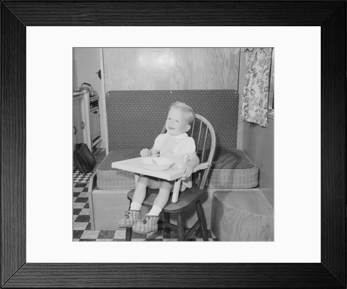 Framed Print : Small boy in high chair enjoying his lunch Circa 1959