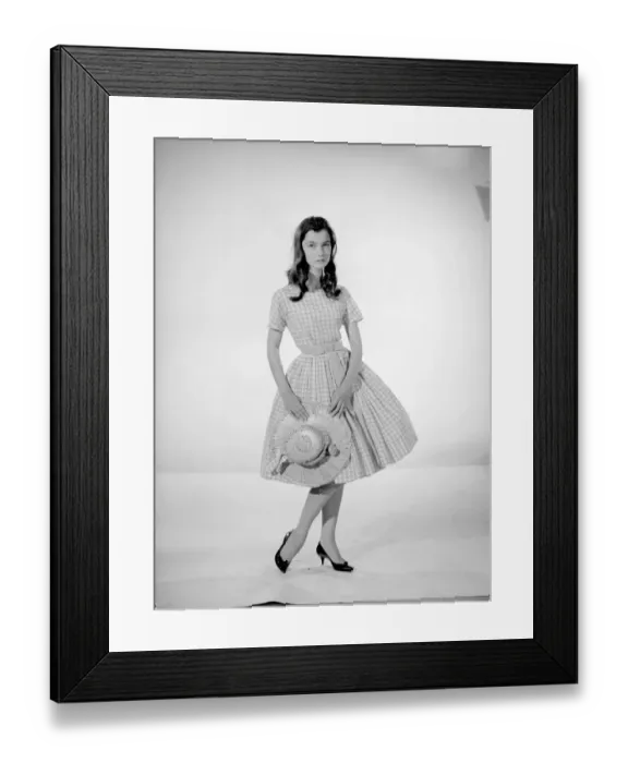 Framed Print : Model Jennifer Goddard. Brown-haired girl in checkered dress with hat