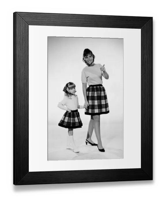 Framed Print : Plaid skirt fashion shoo. Mother and daughter in matching check skirts