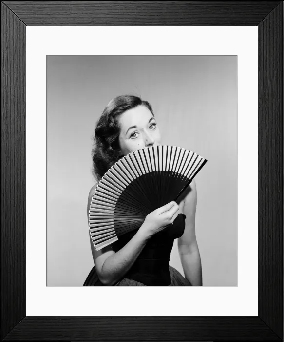 Framed Print : Model with fan in strapless dress. Model with fan in strapless dress. Circa 1964