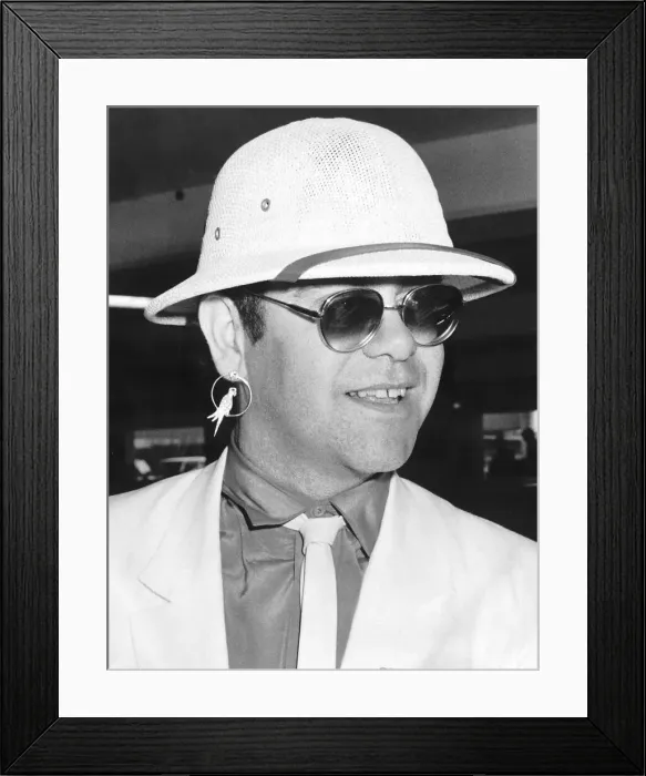 Framed Print : Elton John singer arriving at Heathrow from Sun City, South Africa August 1983