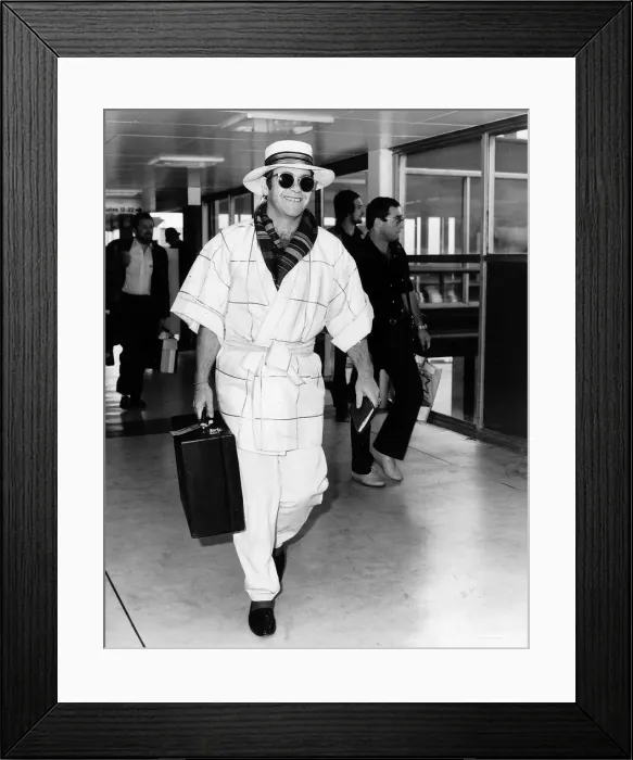 Framed Print : Singer Elton John pictured at Heathrow airport. 11th April 1982 Framed Print : Singer Elton John pictured at Heathrow airport. 11th April 1982