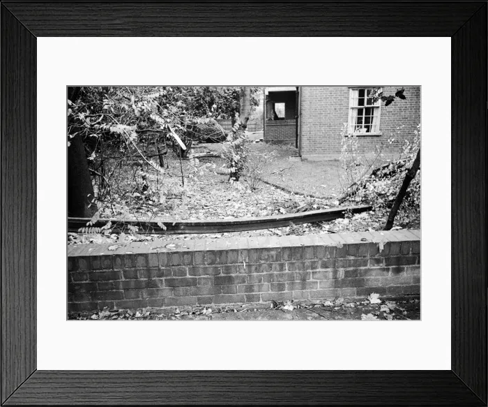 Framed Print : V2 Rocket incident near Palmers Green Station. A piece of rail in a garden after Framed Print : V2 Rocket incident near Palmers Green Station. A piece of rail in a garden after