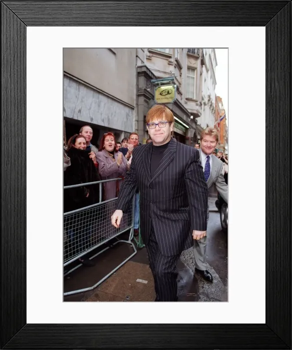 Framed Print : Elton John Singer  /  Songwriter attending the sale of his old cloths with the profits going