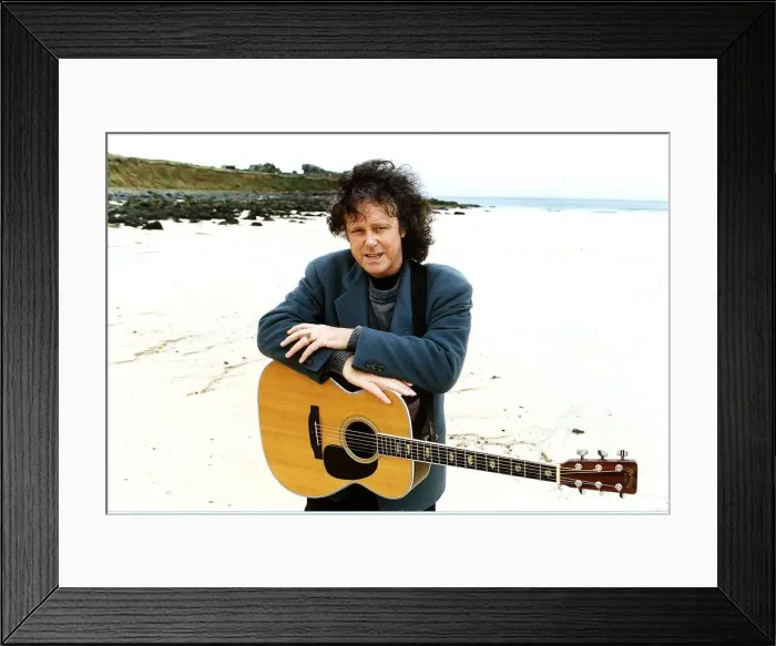 Framed Print : Donovan Pop Star of the 60s pictured at a beach with his guitar hanging around his neck