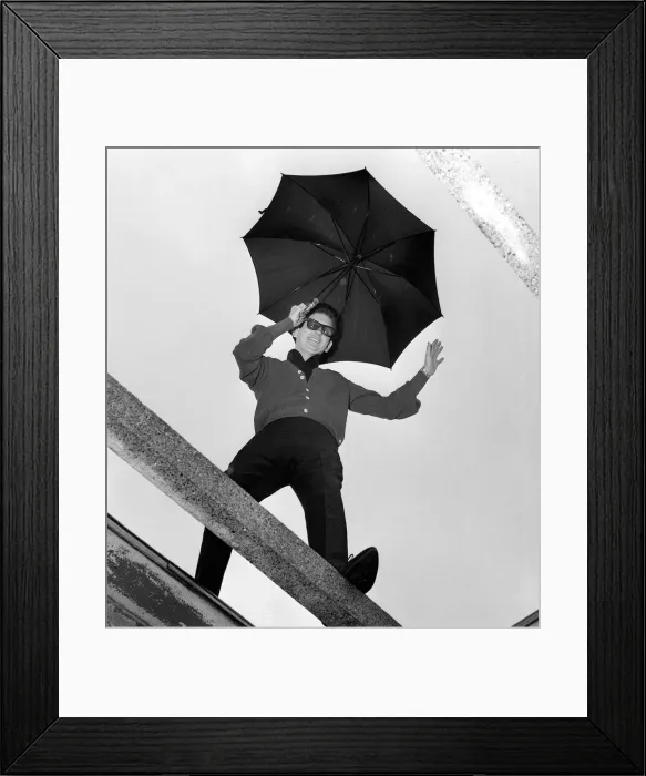 Framed Print : American singer Roy Orbison holding an umbrella at ATV House in London where he has Framed Print : American singer Roy Orbison holding an umbrella at ATV House in London where he has