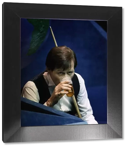 Alex Higgins snooker player during a maych drinking pint of beer