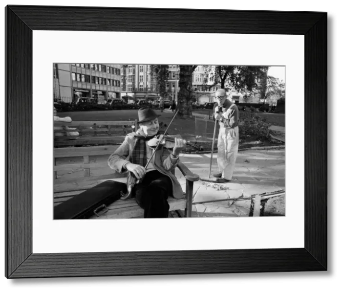 Framed Print : Stephan Grappelli playing his violin in Hanover Square, London watched by park sweeper Framed Print : Stephan Grappelli playing his violin in Hanover Square, London watched by park sweeper