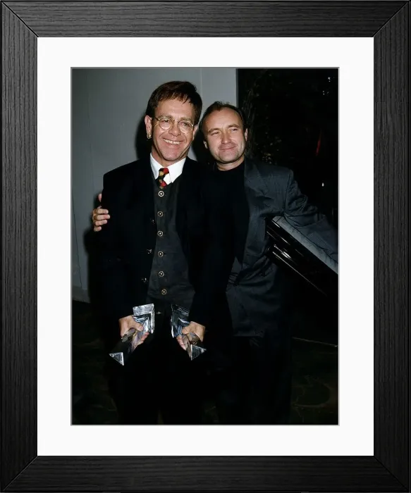 Framed Print : Phil Collins Singer and Elton John at award dinner at Park Lane Hotel