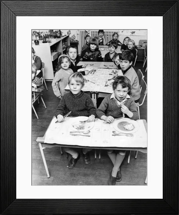 Framed Print : Pupils at Benfieldside School settle down to lunch in the classroom because there are no Framed Print : Pupils at Benfieldside School settle down to lunch in the classroom because there are no