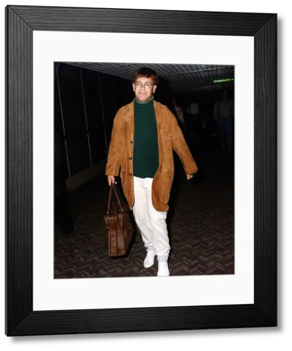 Framed Print : Elton John singer arriving at an airport Framed Print : Elton John singer arriving at an airport