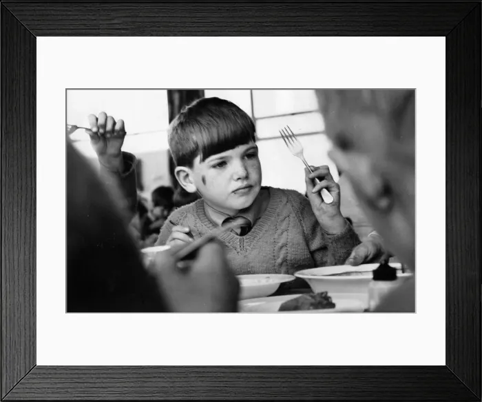 Framed Print : A young pupils enjoying his school lunch Framed Print : A young pupils enjoying his school lunch