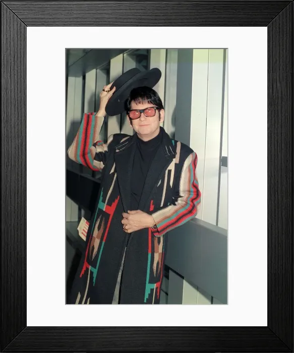 Framed Print : Roy Orbison at Heathrow Airport November 1988 in multi coloured coat holding