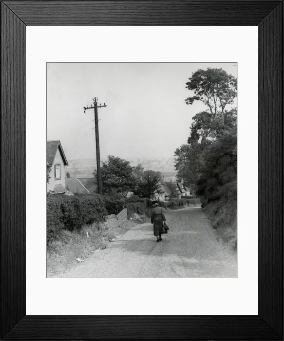 Framed Print : Rear view of a woman walking down a rural country lane near West Bromwich in the West