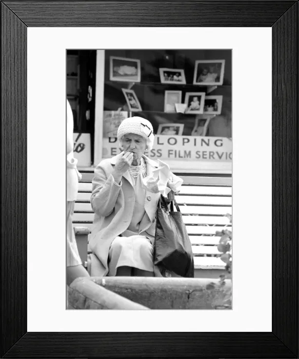 Framed Print : An old lady enjoying fish and chips during a day out to the beach at Trecco Bay Framed Print : An old lady enjoying fish and chips during a day out to the beach at Trecco Bay