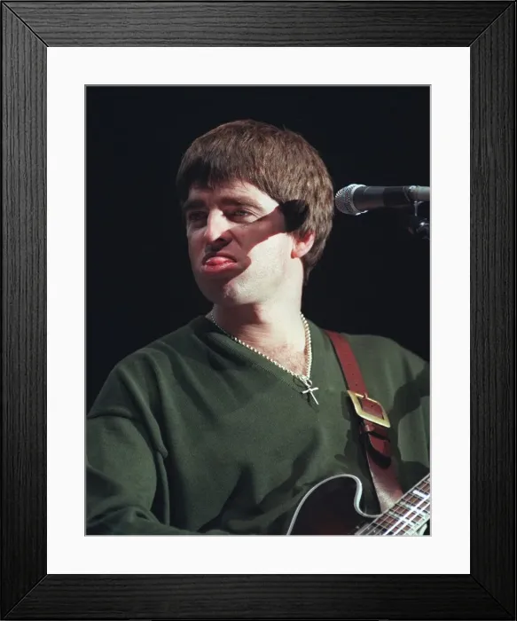 Framed Print : Noel Gallagher Oasis pop group December 1997 Sticking tongue out playing guitar Framed Print : Noel Gallagher Oasis pop group December 1997 Sticking tongue out playing guitar