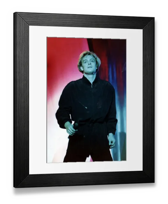 Framed Print : Jason Donovan on stage in Edinburgh face lit green blue black shirt trousers holding