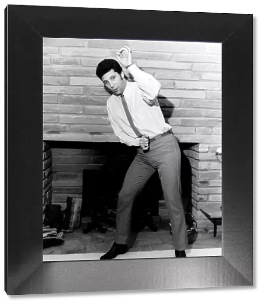Tom Jones singer dancing in front of fireplace