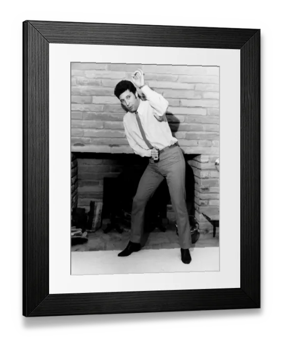 Framed Print : Tom Jones singer dancing in front of fireplace Framed Print : Tom Jones singer dancing in front of fireplace