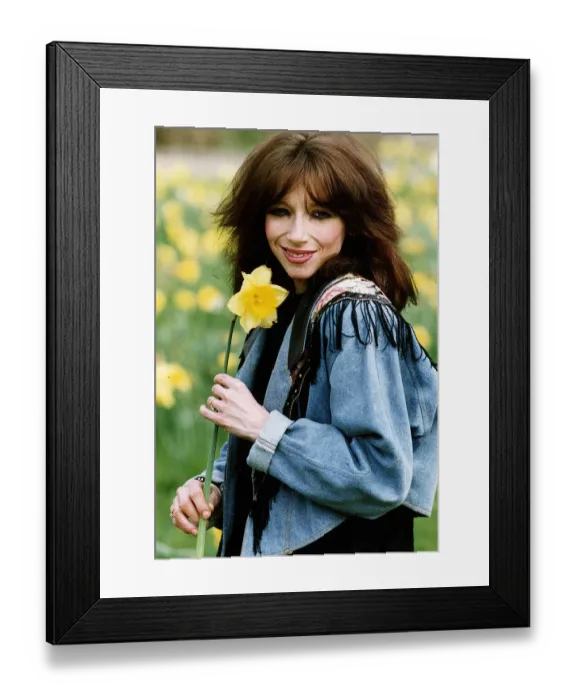 Framed Print : Lena Zavaroni singer with daffodil flower outisde her house in London. April 1993