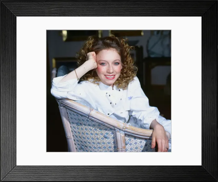 Framed Print : Lena Zavaroni sitting in whicker chair, wearing a white jump suit, aged 22. December 1985 Framed Print : Lena Zavaroni sitting in whicker chair, wearing a white jump suit, aged 22. December 1985