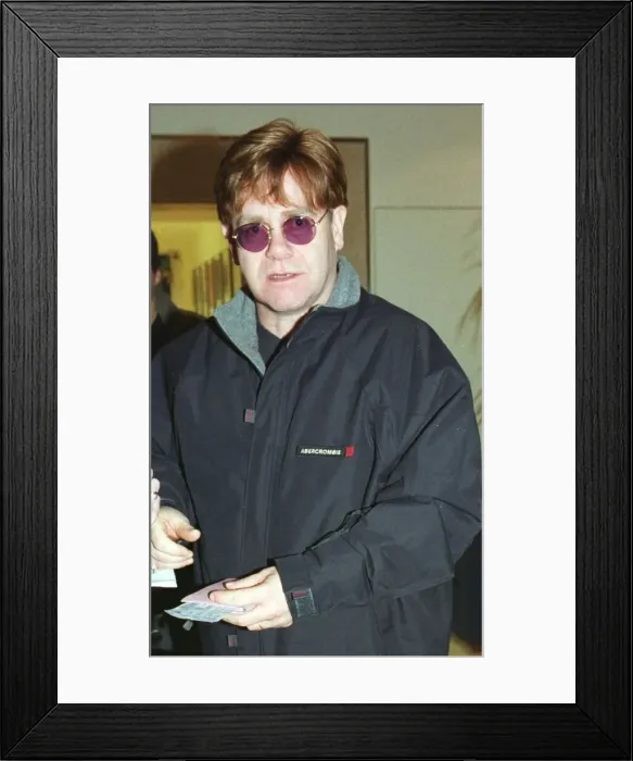 Framed Print : Sir Elton John December 1999 leaves Heathrow Airport for Los Angeles Framed Print : Sir Elton John December 1999 leaves Heathrow Airport for Los Angeles