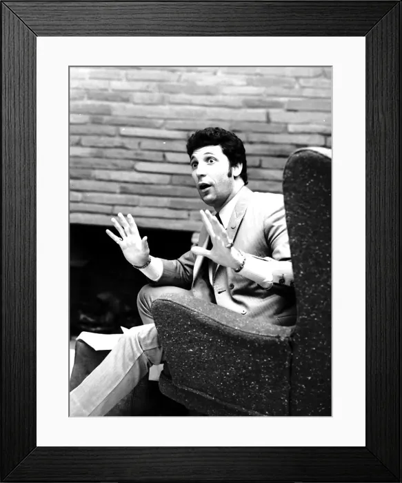 Framed Print : Tom Jones singer hands up sitting on armchair Framed Print : Tom Jones singer hands up sitting on armchair