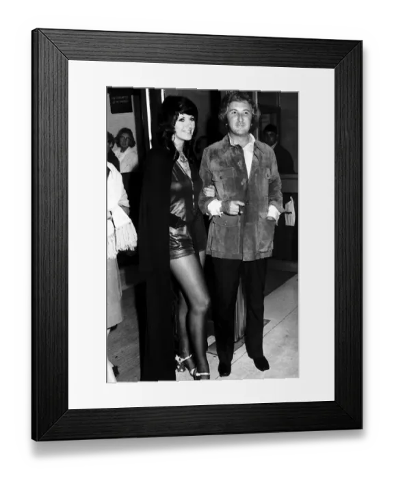 Framed Print : Film Producer Michael Winnner is accompanied by model Valli Kemp at a Film Premiere of