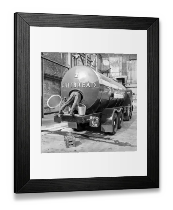Framed Print : A tanker driver seen here cleaning out the inside of his vehicle at the Whitbread brewery Framed Print : A tanker driver seen here cleaning out the inside of his vehicle at the Whitbread brewery