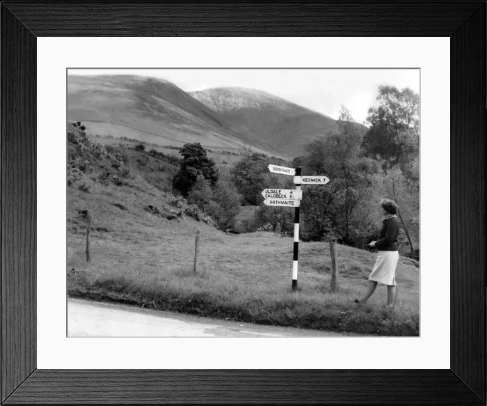 Framed Print : Lake District - A sign post points a woman in the right direction near Orthwaite 1 May Framed Print : Lake District - A sign post points a woman in the right direction near Orthwaite 1 May