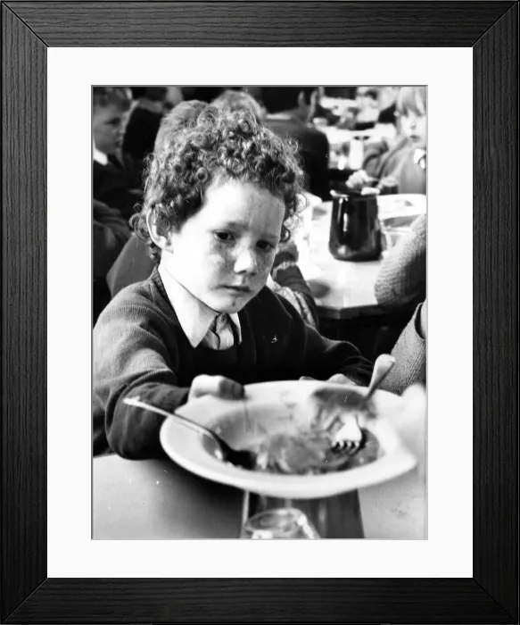 Framed Print : Please sir, I want some more, this little boy has enjoyed his school meal Framed Print : Please sir, I want some more, this little boy has enjoyed his school meal