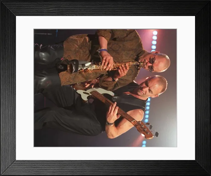 Framed Print : Sting rock singer performing live on stage in Aberdeen with guitar beside his saxaphone Framed Print : Sting rock singer performing live on stage in Aberdeen with guitar beside his saxaphone
