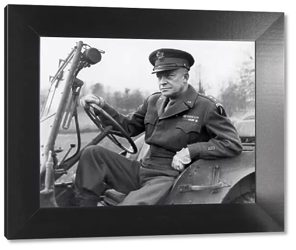 General Dwight D Eisenhower seated in a jeep on his way to deliver his Christmas message
