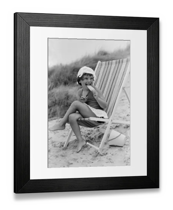 Framed Print : Four year old Joanna Weaver of Fordcombe, Kent enjoys an ice lolly as she sits in a deck