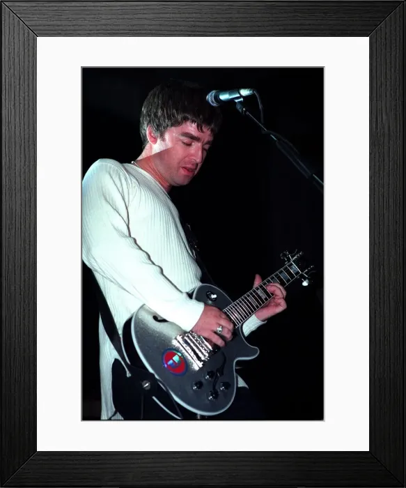 Framed Print : Noel Gallagher of the pop group Oasis playing guitar Sept 97 Framed Print : Noel Gallagher of the pop group Oasis playing guitar Sept 97