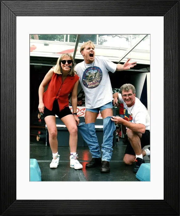 Framed Print : Jason Donovan Balloch Park Radio 1 roadshow having his jeans cut off by Smiley Framed Print : Jason Donovan Balloch Park Radio 1 roadshow having his jeans cut off by Smiley
