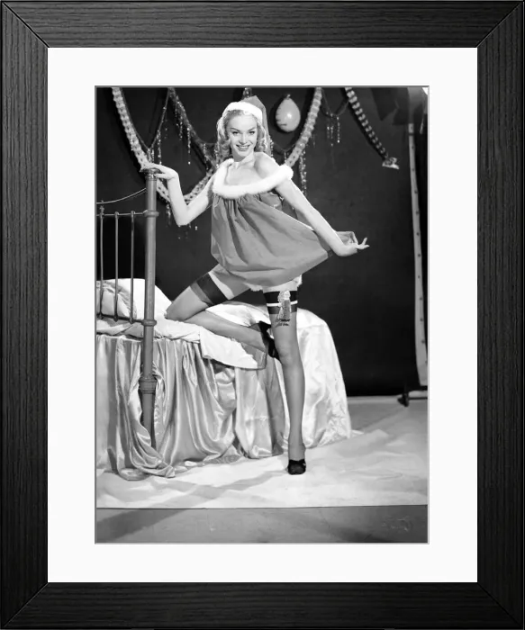 Framed Print : Woman putting up her Christmas stocking. 1959 E368-002 Framed Print : Woman putting up her Christmas stocking. 1959 E368-002
