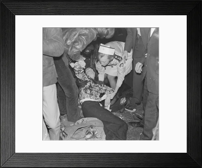 Framed Print : Rolling Stones. A fanlays on the ground being tended to by a St Johns Ambulance Brigade Framed Print : Rolling Stones. A fanlays on the ground being tended to by a St Johns Ambulance Brigade